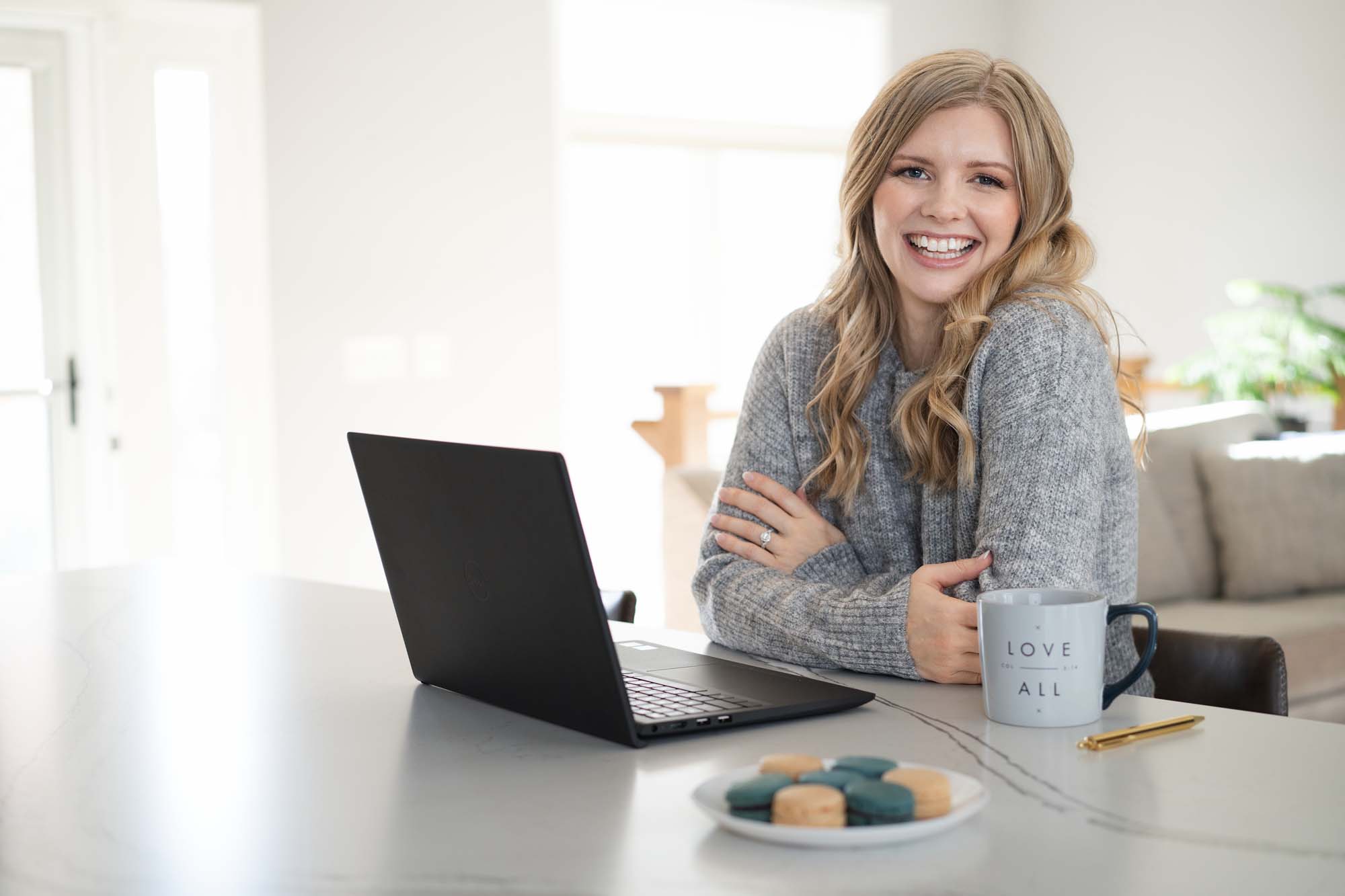 Smiling Web Designer sitting in front of open laptop